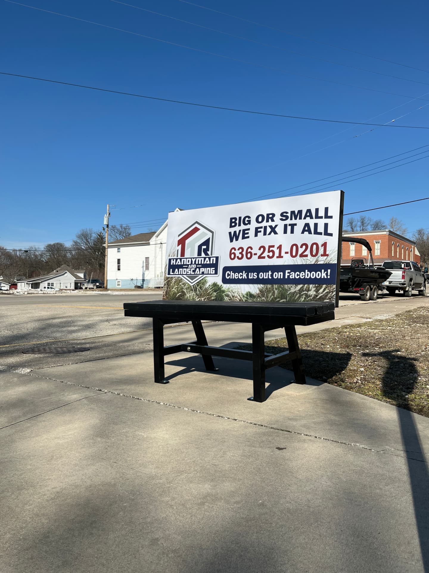 Handyman and Landscaping Benchboard installed along a local street